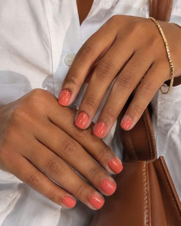Glossy Coral Nails With Gold Dots